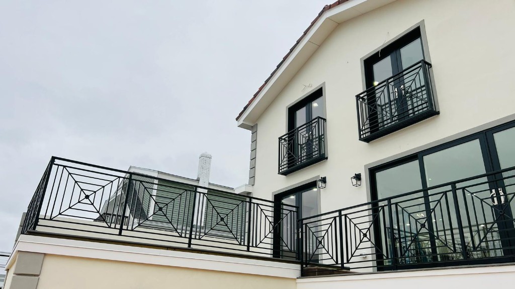 Geometric black iron balcony and terrace railings on a custom home