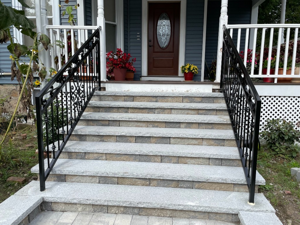 Decorative iron railings on stone steps with custom scrollwork