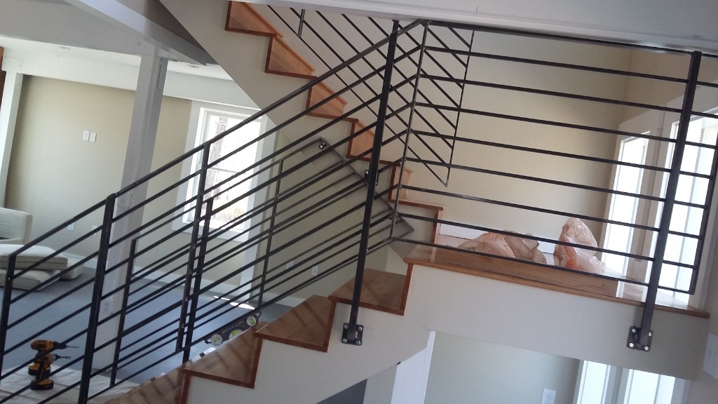 Interior stair railing with horizontal bars and a diamond infill panel