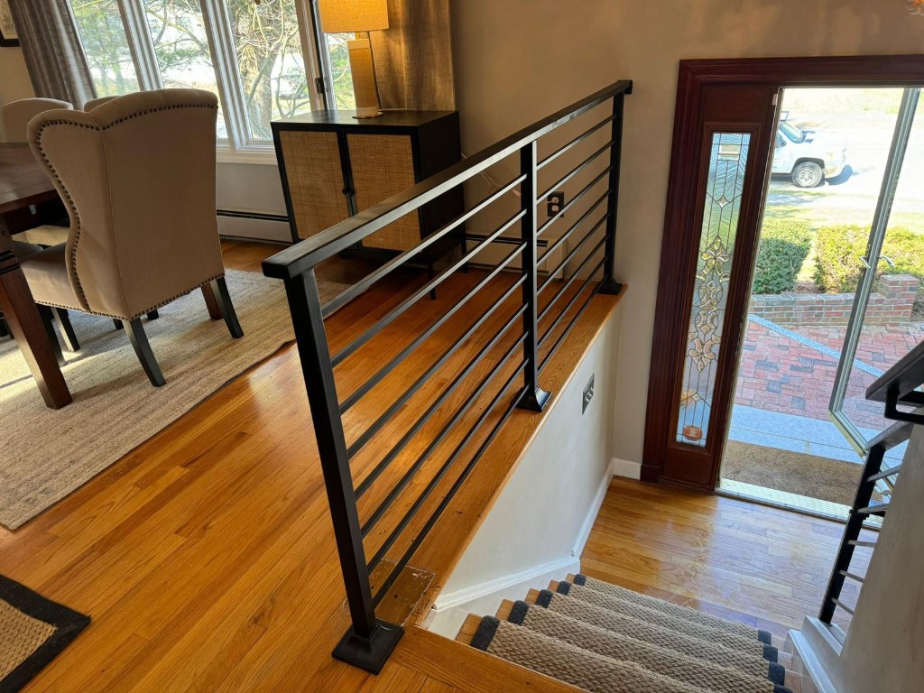 Horizontal bar guard between a dining room and the stair opening