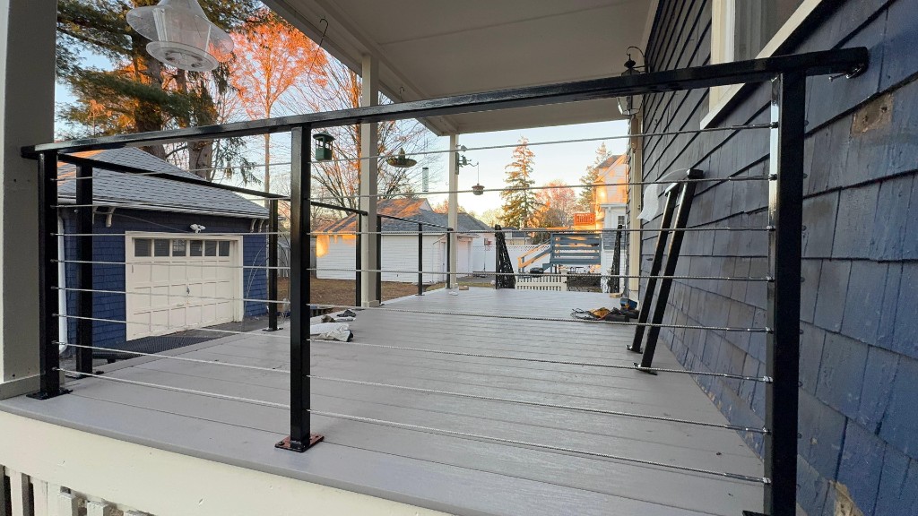 Cable railing with black steel posts on a covered deck