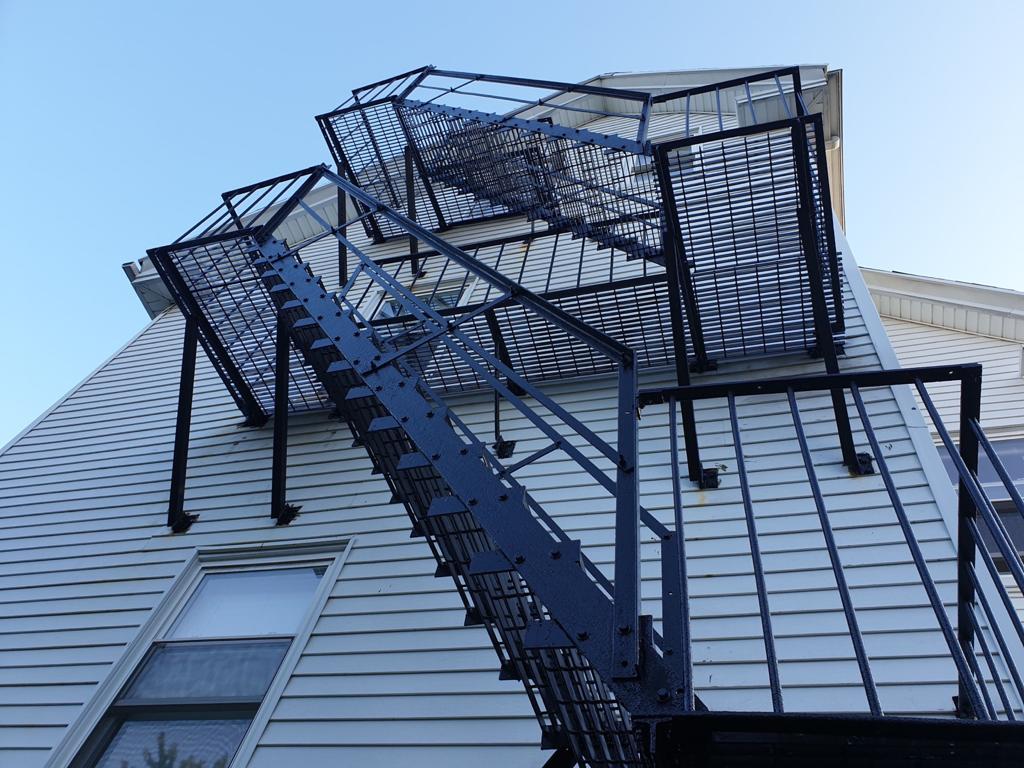 Multi-story steel fire escape with open grating stairs and railings, Massachusetts building